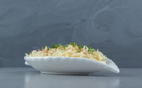 pasta-with-chopped-parsley-leaf-shaped-plate_114579-73724