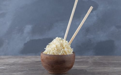 small-bowl-shredded-pasta-chopstick-marble-surface_114579-63819